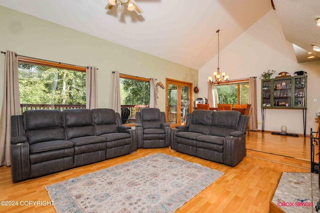 living room featuring a healthy amount of sunlight, light wood-style flooring, and high vaulted ceiling