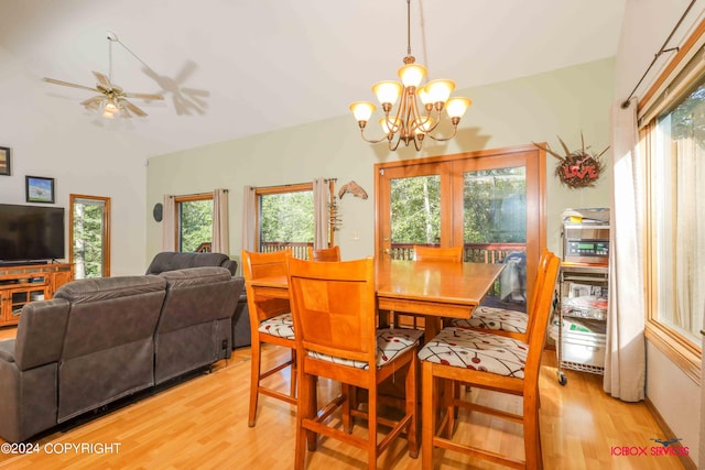 dining room with light wood-style flooring and ceiling fan with notable chandelier