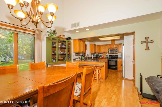 dining room with light wood-style floors, recessed lighting, visible vents, and an inviting chandelier