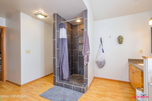 bathroom with vanity, hardwood / wood-style flooring, and walk in shower