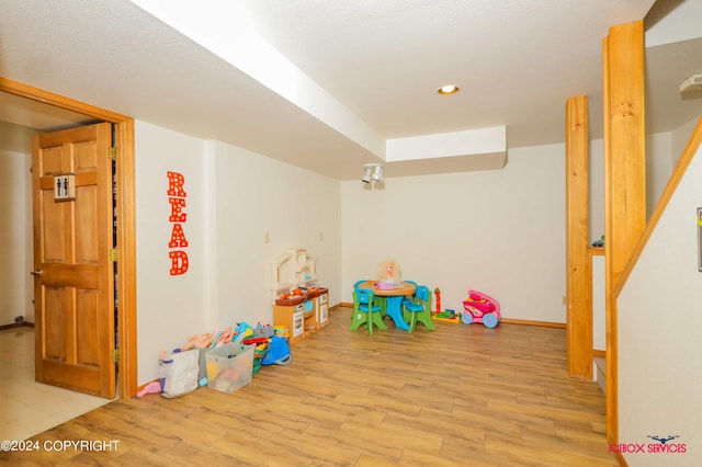 playroom with baseboards, wood finished floors, and recessed lighting