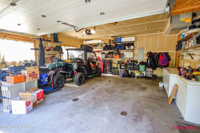 garage featuring electric panel and a garage door opener