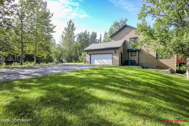 view of front facade with a garage and a front lawn