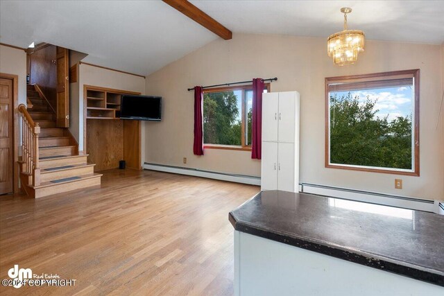 unfurnished living room with light wood-type flooring, baseboard heating, an inviting chandelier, and vaulted ceiling with beams