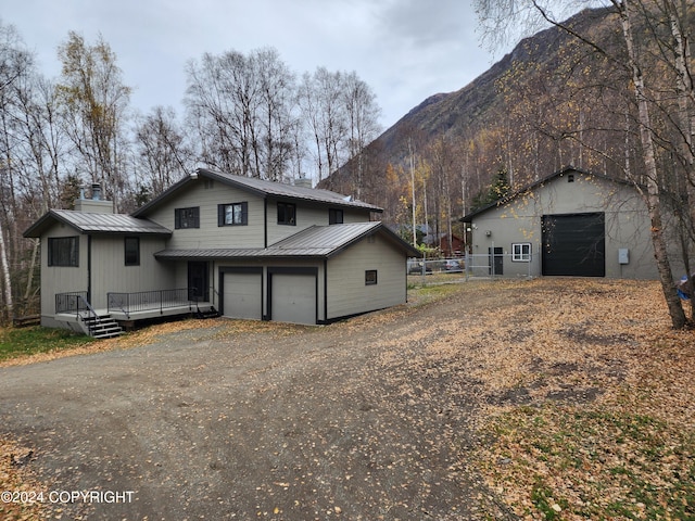 exterior space with a deck with mountain view and a garage