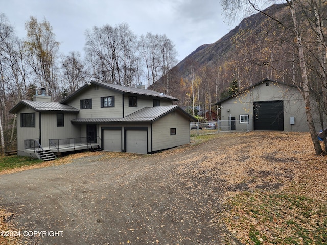 view of home's exterior with a deck with mountain view and a garage