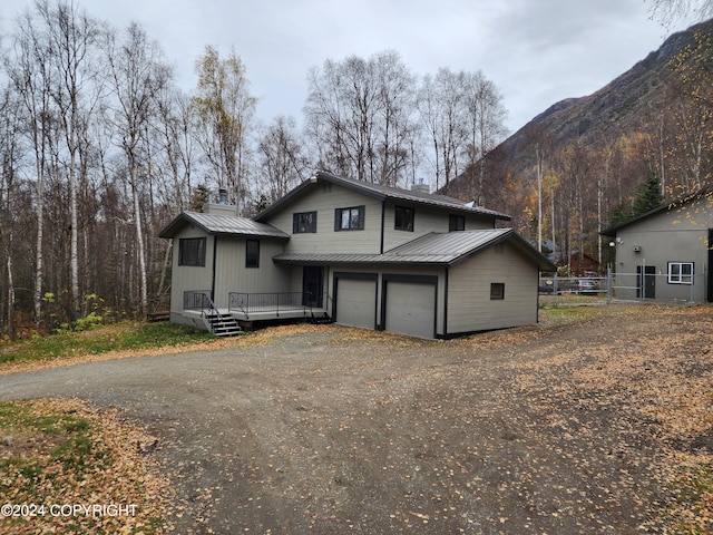 view of front facade featuring a garage and a deck with mountain view