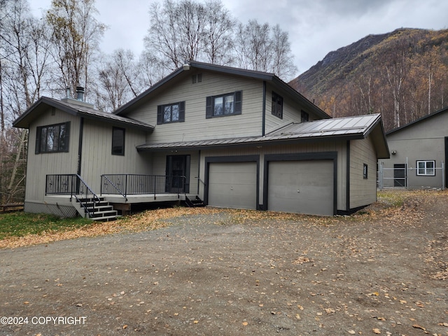 view of front of property with a mountain view and a garage