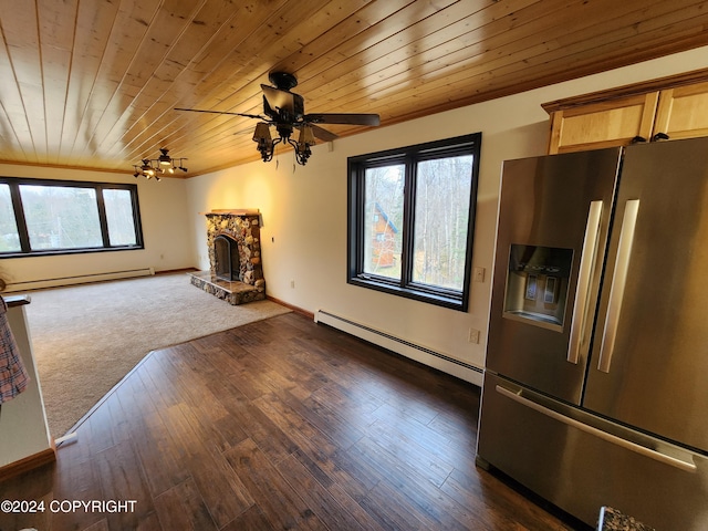 unfurnished living room with baseboard heating, a stone fireplace, ceiling fan, and wood ceiling