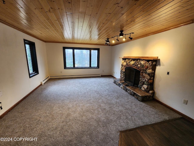 unfurnished living room with carpet, a stone fireplace, wooden ceiling, and crown molding