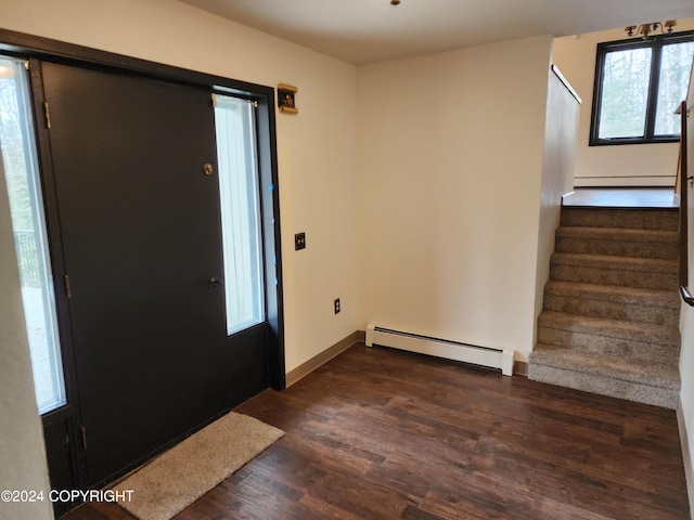 entrance foyer with dark wood-type flooring and a baseboard heating unit