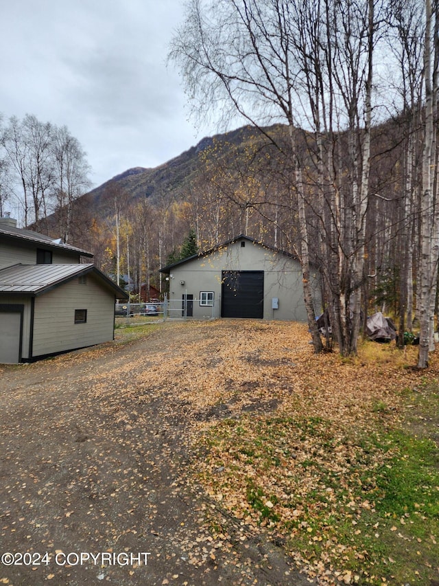 view of home's exterior featuring a mountain view, an outbuilding, and a garage