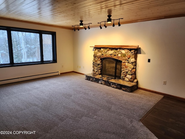 unfurnished living room with carpet flooring, ornamental molding, a baseboard heating unit, wooden ceiling, and a fireplace