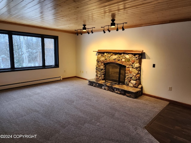 unfurnished living room with wood ceiling, crown molding, a baseboard heating unit, carpet floors, and a stone fireplace