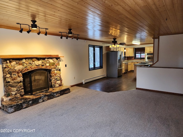 unfurnished living room with crown molding, a stone fireplace, a baseboard heating unit, and wood ceiling