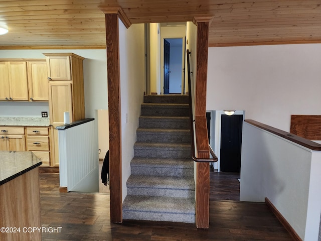 staircase with hardwood / wood-style flooring, crown molding, and wooden ceiling