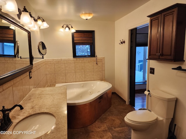 bathroom with tile patterned floors, vanity, a bath, and toilet