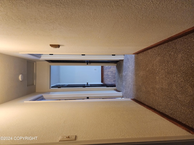 corridor with a textured ceiling