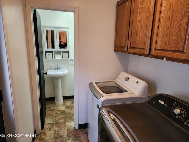 clothes washing area featuring washing machine and clothes dryer and sink