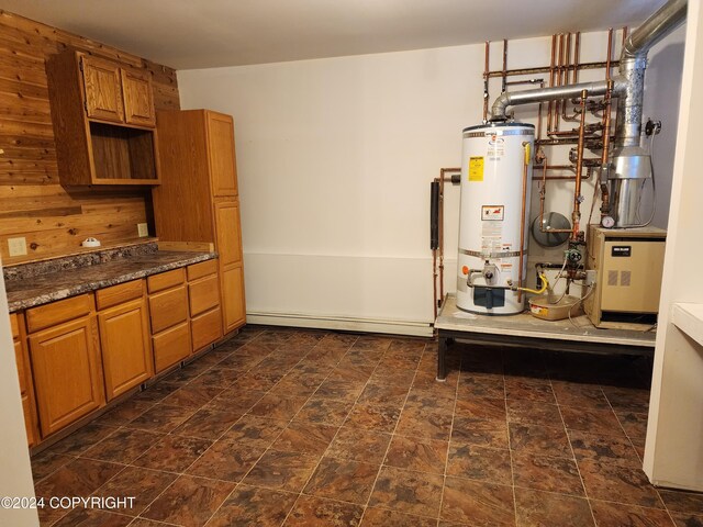 20527 Mark Cir, Chugiak, AK 99567 - kitchen with secured water heater, brown cabinets, stone finish floors, and dark countertops