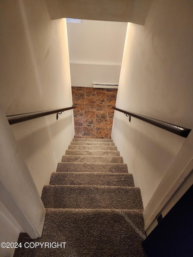 20527 Mark Cir, Chugiak, AK 99567 - stairs with a baseboard heating unit and stone finish floors