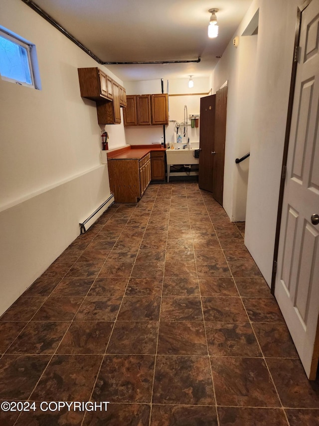 20527 Mark Cir, Chugiak, AK 99567 - kitchen with baseboard heating and brown cabinetry