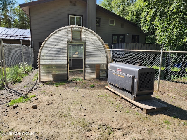 20527 Mark Cir, Chugiak, AK 99567 - rear view of property featuring a greenhouse and an outdoor structure