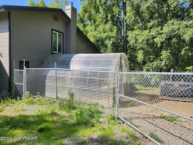 20527 Mark Cir, Chugiak, AK 99567 - view of home's exterior with a chimney