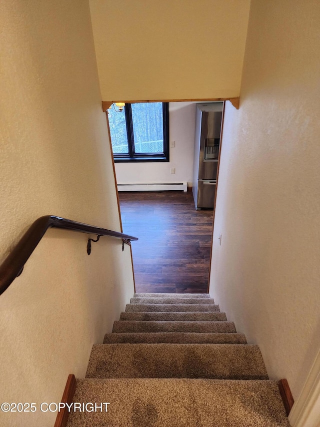 20527 Mark Cir, Chugiak, AK 99567 - stairway with a baseboard heating unit, wood finished floors, and a textured wall