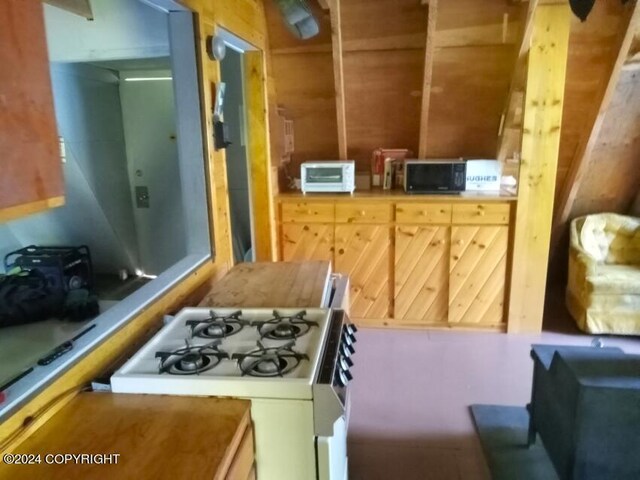 kitchen featuring white range with gas cooktop