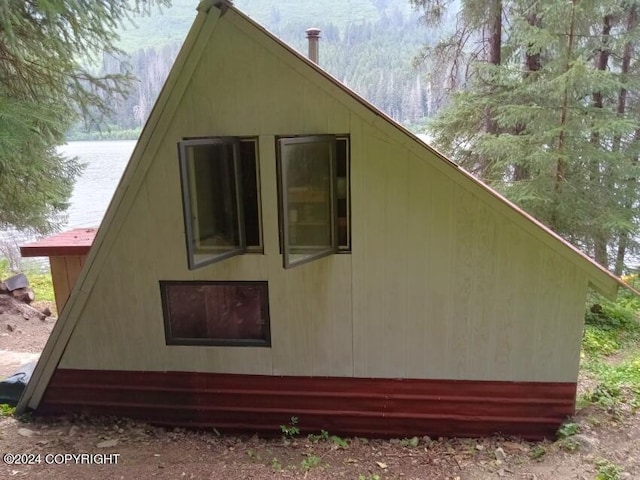 view of property exterior featuring a water view