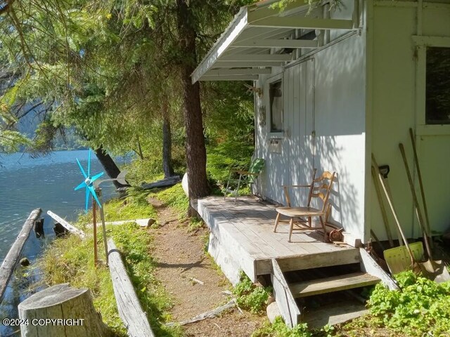 exterior space featuring a deck with water view