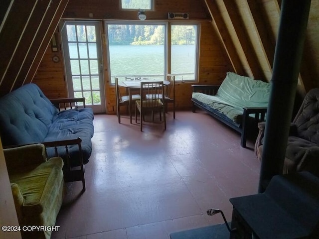 sitting room featuring lofted ceiling and a water view