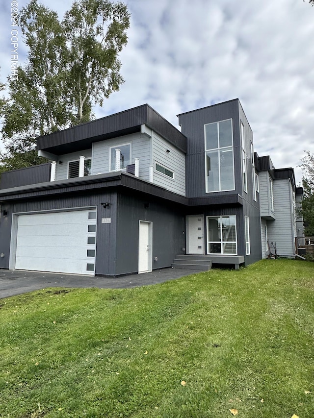 view of front facade with a garage and a front lawn