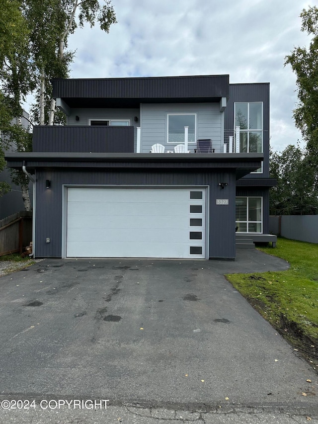 view of front facade featuring a garage and a balcony