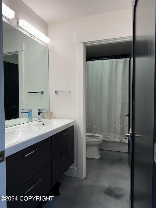 bathroom with concrete flooring, vanity, toilet, and walk in shower