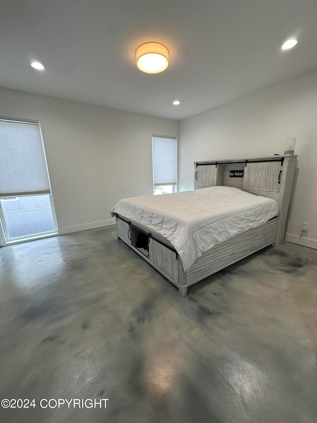 bedroom featuring concrete flooring