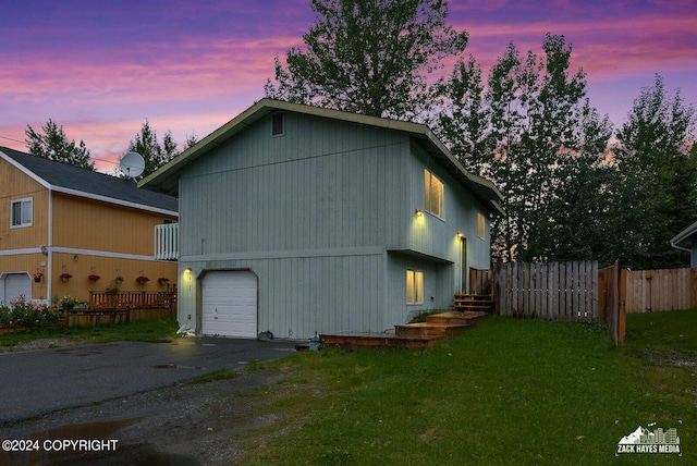 view of front of house with a garage and a lawn