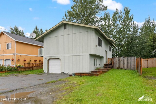 view of front of property with a garage and a front yard