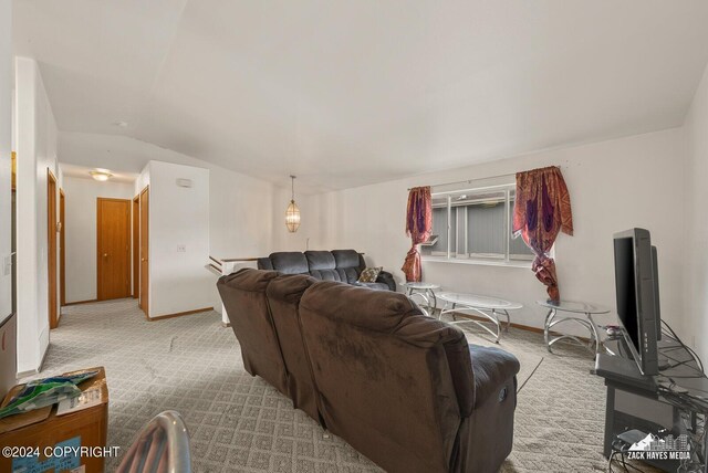 living room featuring light carpet and vaulted ceiling