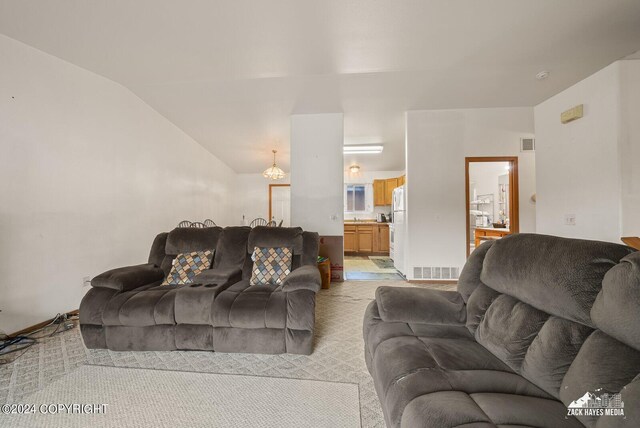 living room with lofted ceiling and light colored carpet