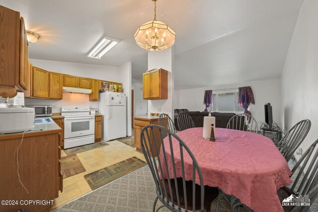 interior space featuring vaulted ceiling and a notable chandelier