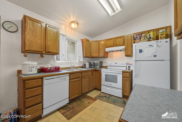 kitchen featuring vaulted ceiling, white appliances, and sink