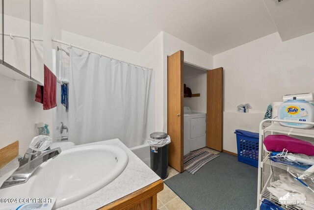 bathroom with tile patterned floors, separate washer and dryer, shower / tub combo with curtain, and vanity