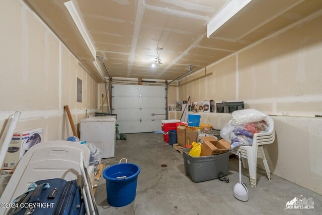 garage featuring electric panel and washer / dryer