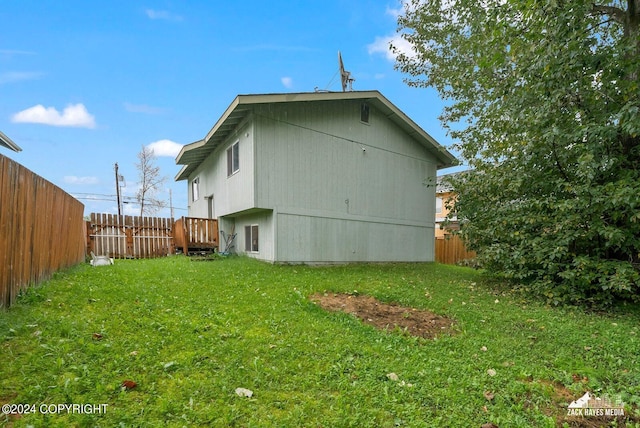 view of side of property featuring a yard