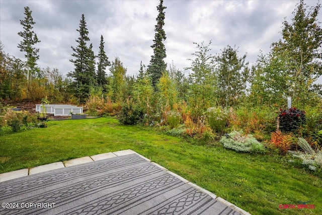 wooden terrace featuring a yard