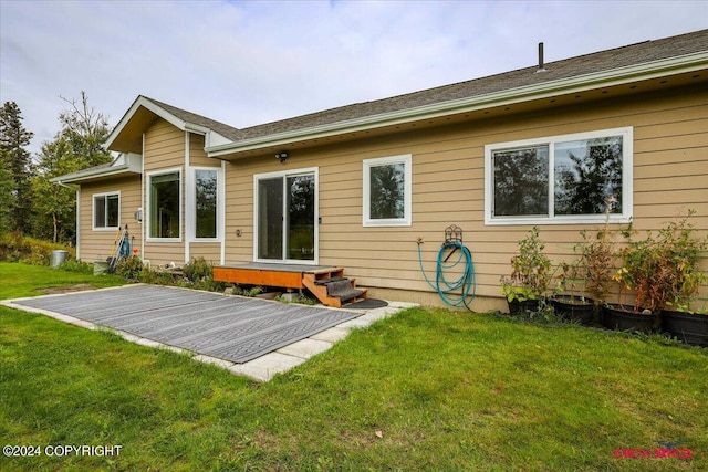 rear view of property with a yard