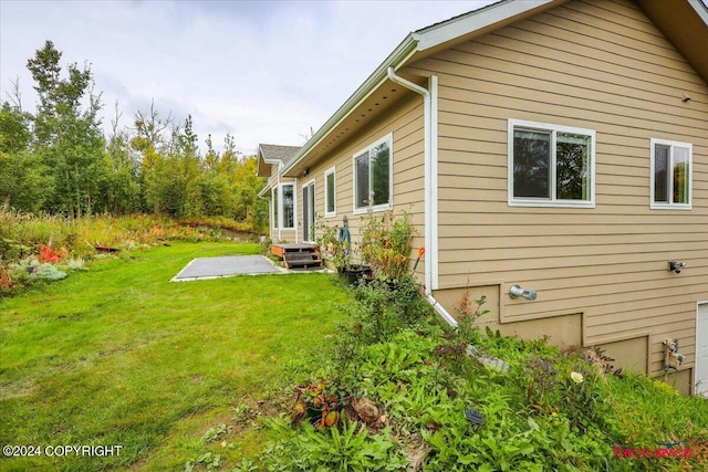 view of side of home featuring a lawn