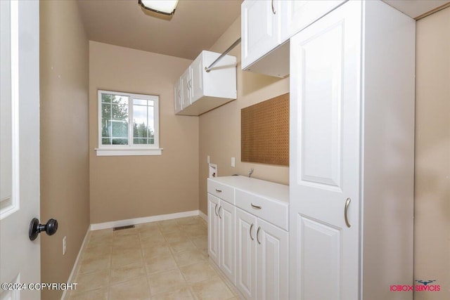 laundry room with hookup for a washing machine and cabinets